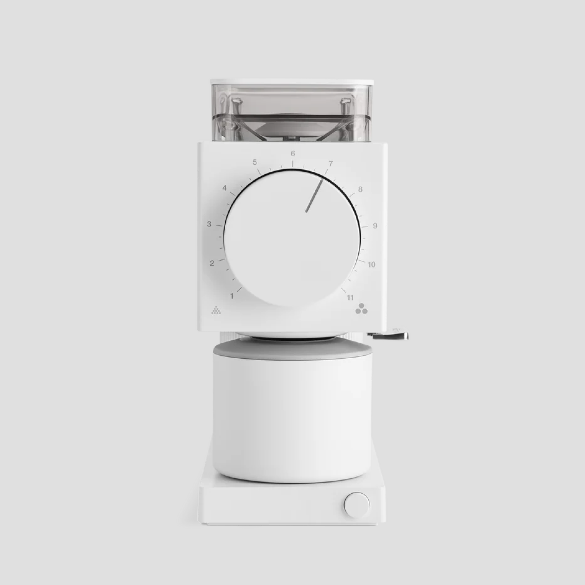Coffee grinder with a modern and minimalist design in white. It features a large central dial with numbers from 1 to 11 to adjust the grind, and a ground coffee container at the bottom. The design is clean, with straight lines and subtle light gray details.