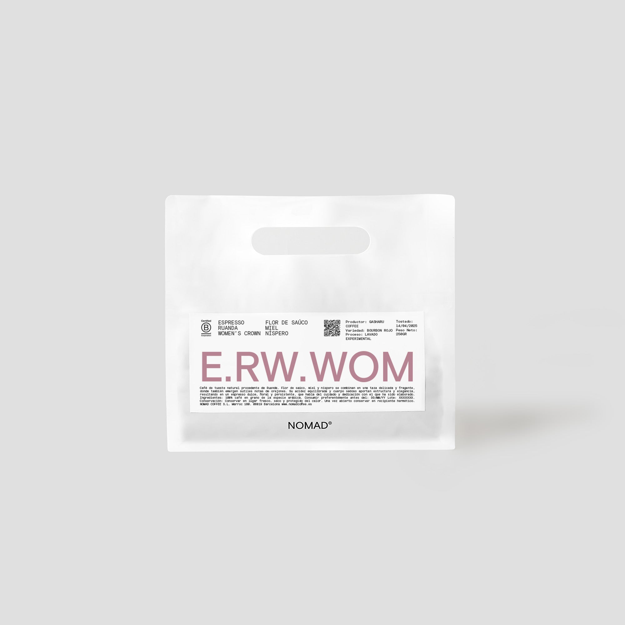 Bossa blanca de cafè de Nomad amb etiqueta “E.RW.WOM” en color bordeus, varietat espresso amb notes de flor de saüc i nespre, presentada en format pla amb nansa encunyada.