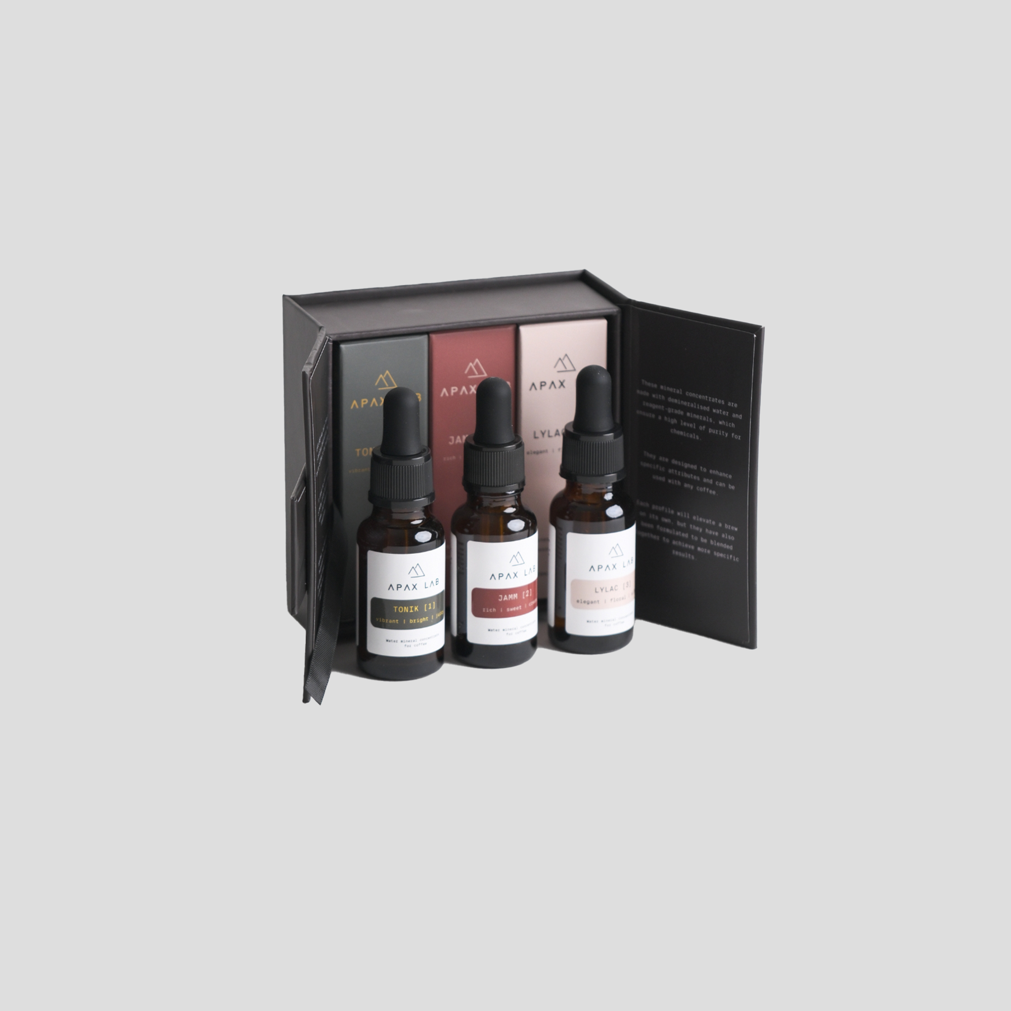 Set de tres concentrats minerals Apax Lab amb estoig obert i disseny de colors sobris.
