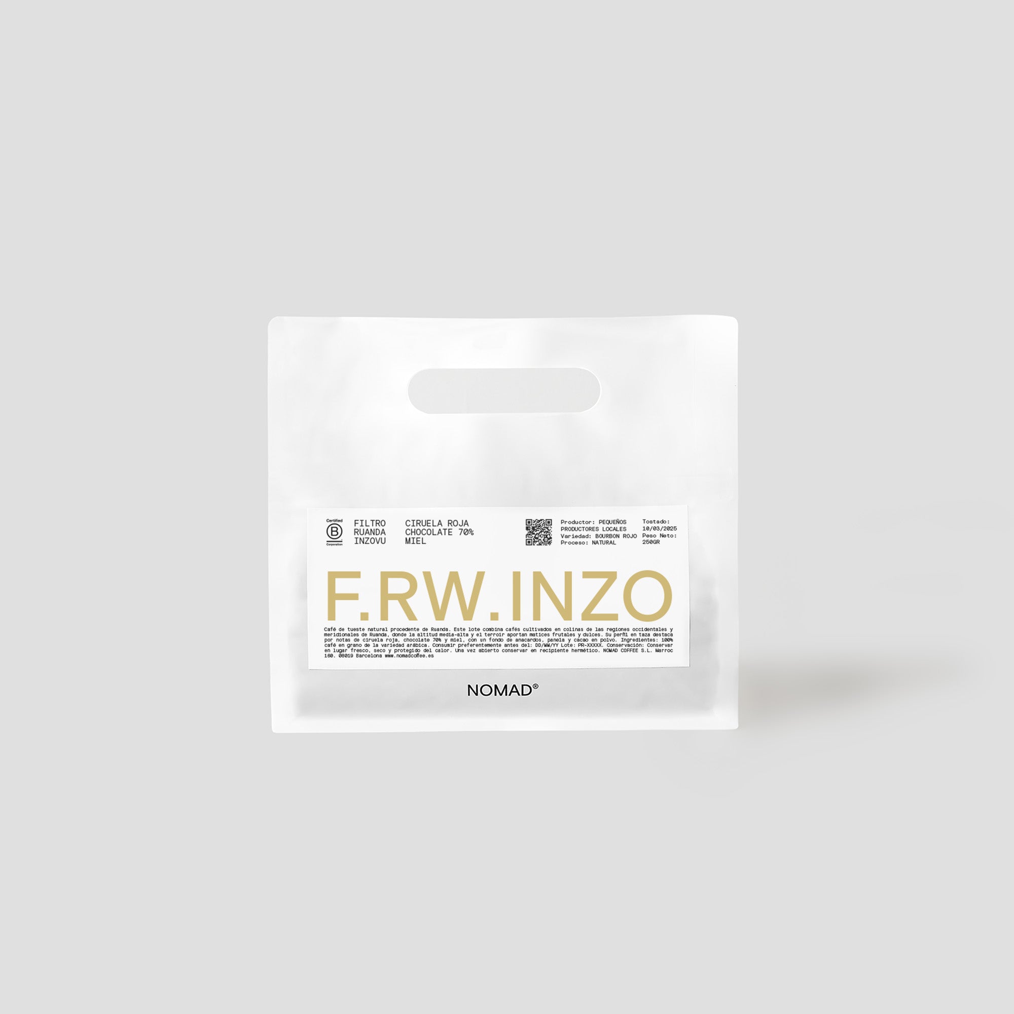 White NOMAD coffee bag with yellow label indicating the code "F.RW.INZO". At the top you can read the tasting notes: red cherry, chocolate and honey tea. The bag has a clean and modern design with die-cut handles.